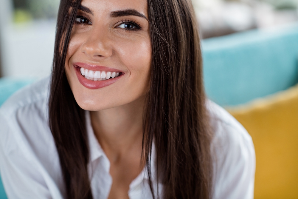 Close-up of a woman's white, evenly aligned smile, an example of cosmetic dentistry results near La Jolla 