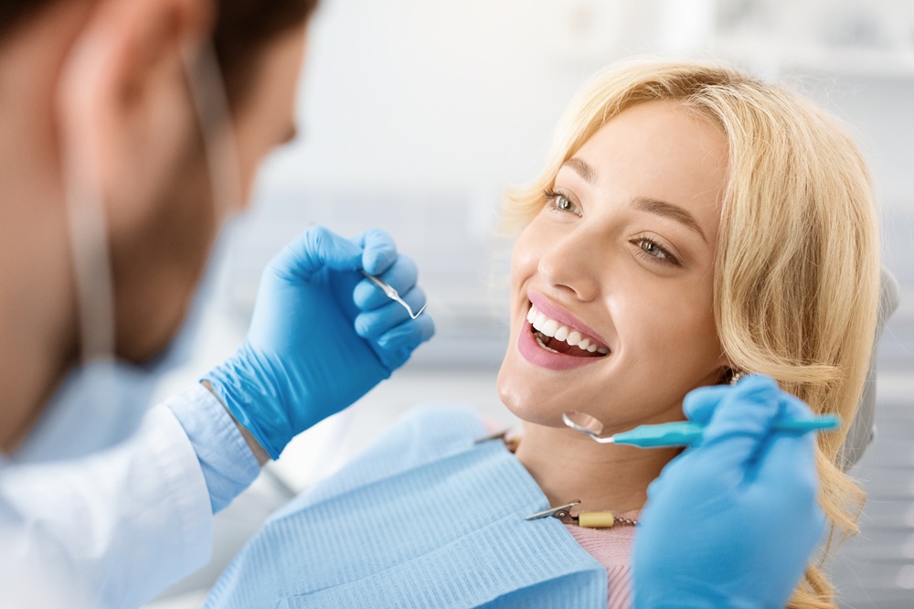 Patient receiving a dental exam and cleaning from a dentist in La Jolla, CA