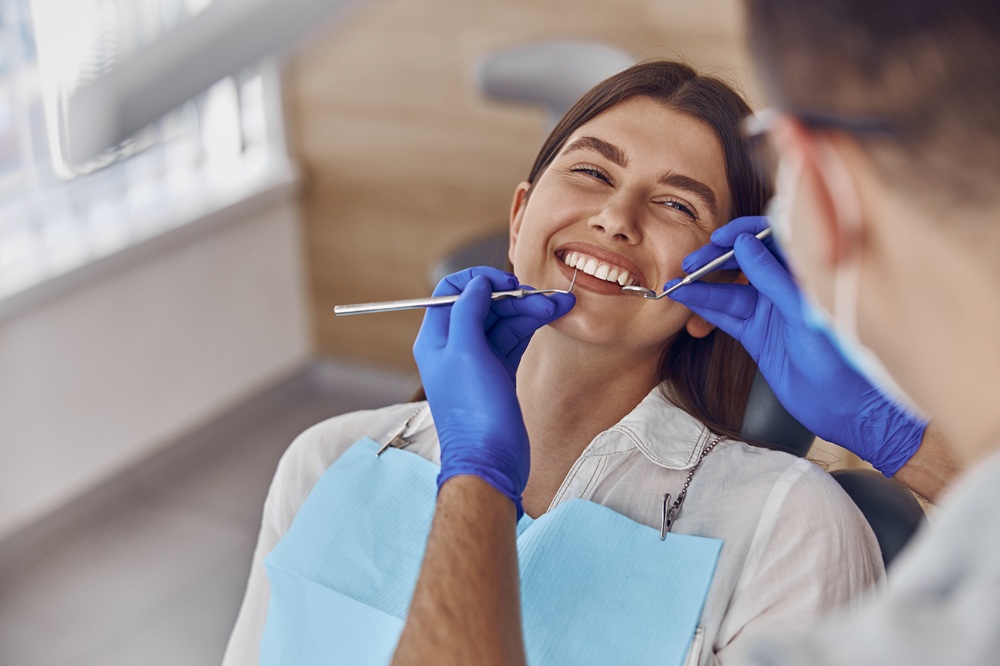 Patient smiling during a professional dental cleaning in La Jolla, CA